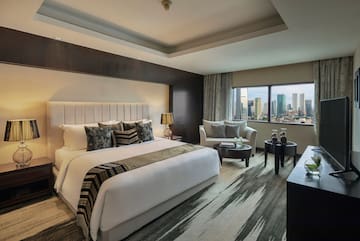 a room with a bed and a table and chairs