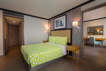 a bed with yellow sheets in a room