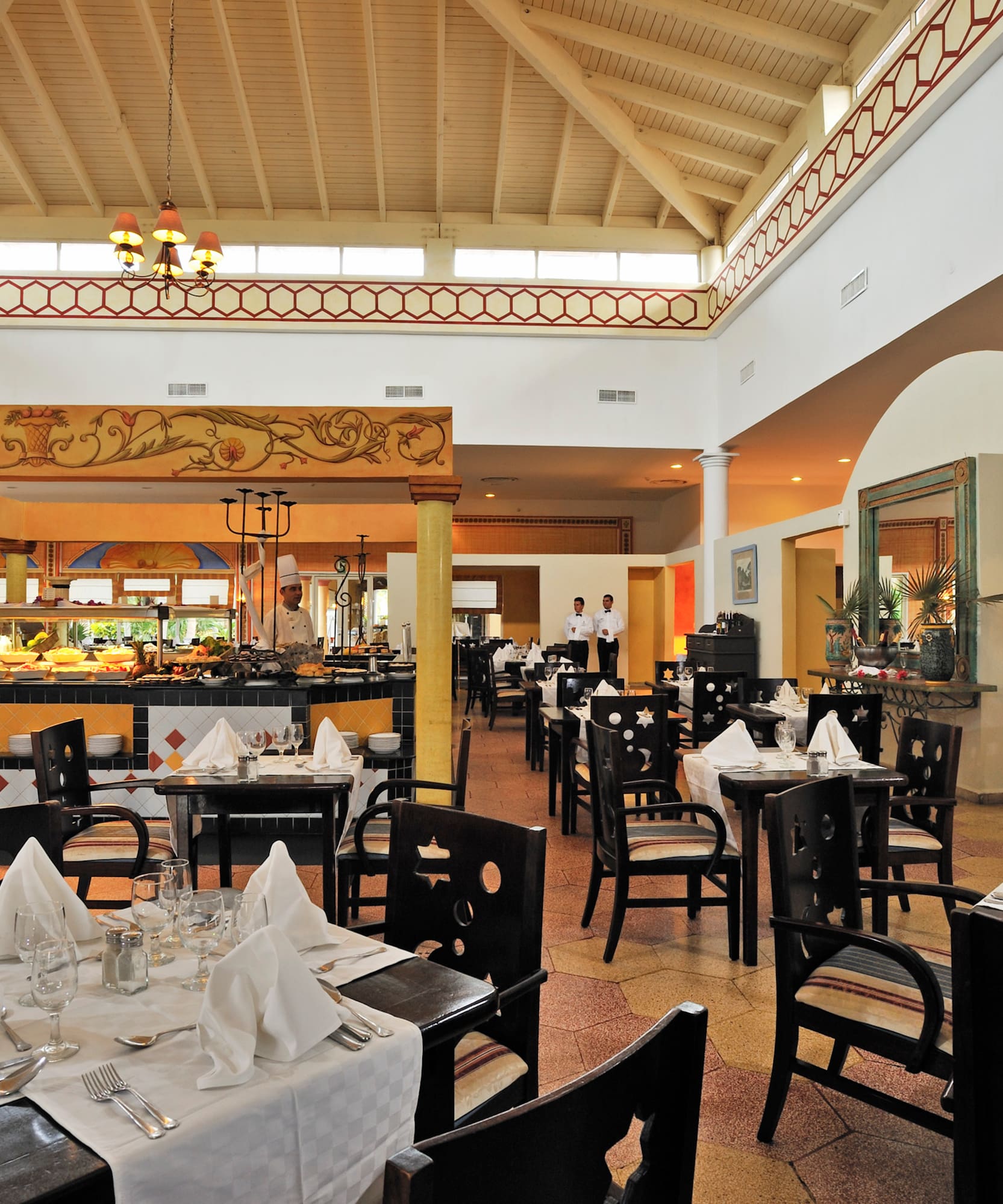 a restaurant with a waiter in the background