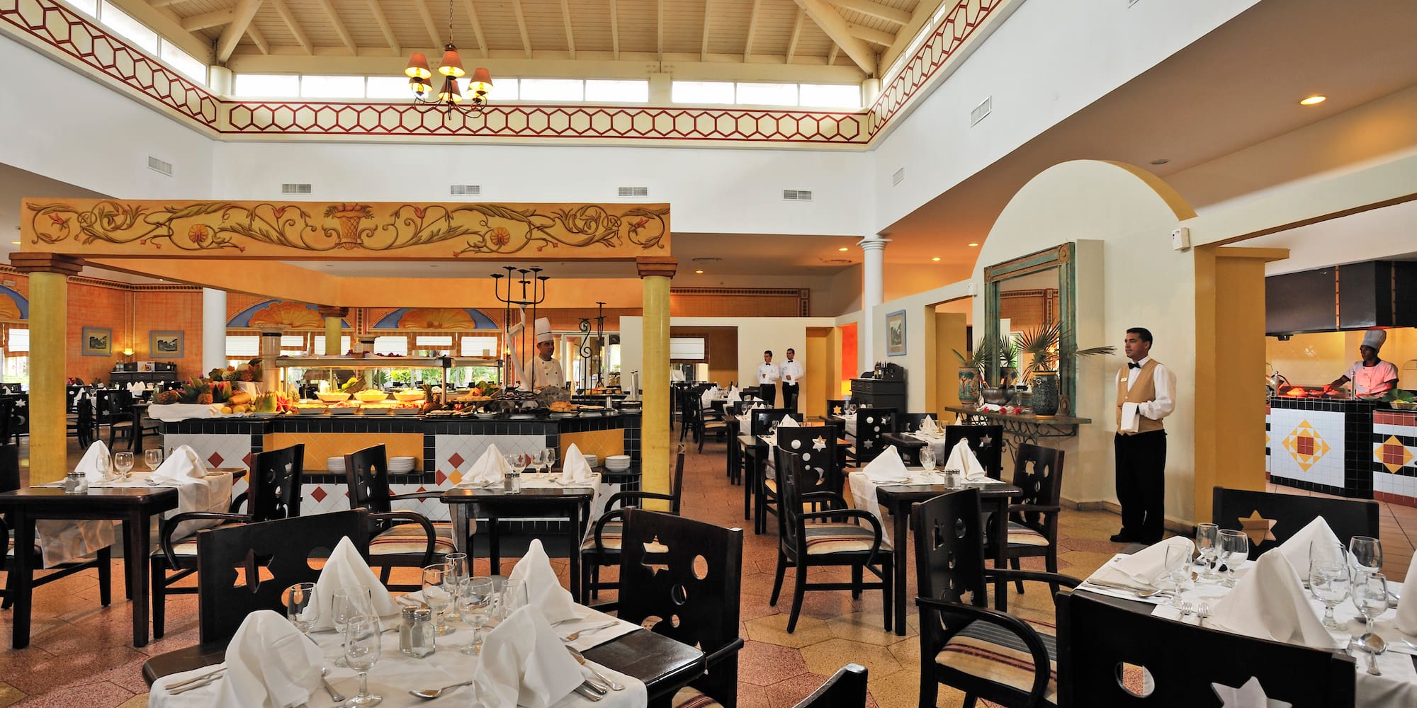 a restaurant with a waiter in the background