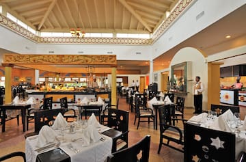 a restaurant with a waiter in the background