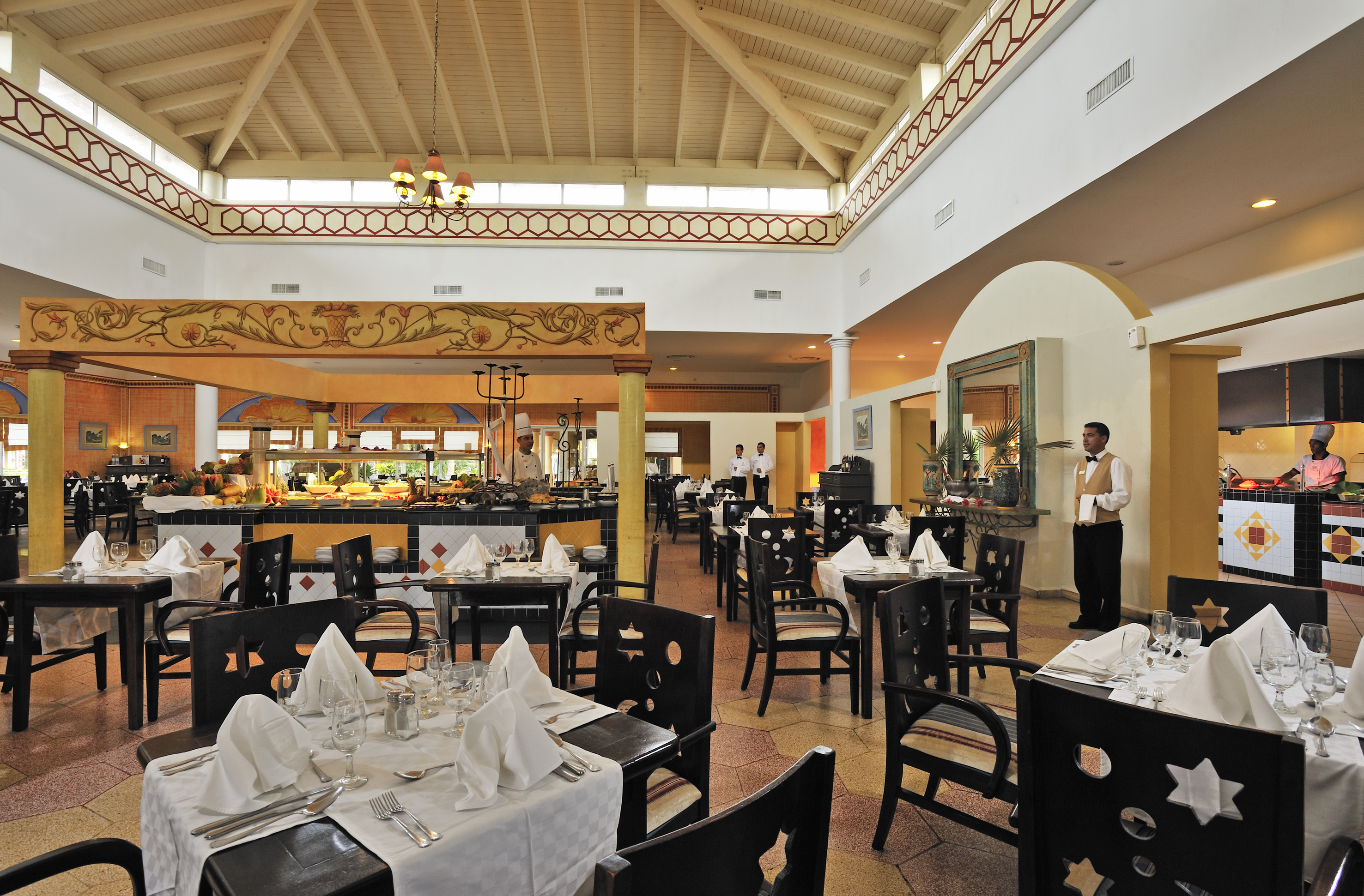 a restaurant with a waiter in the background