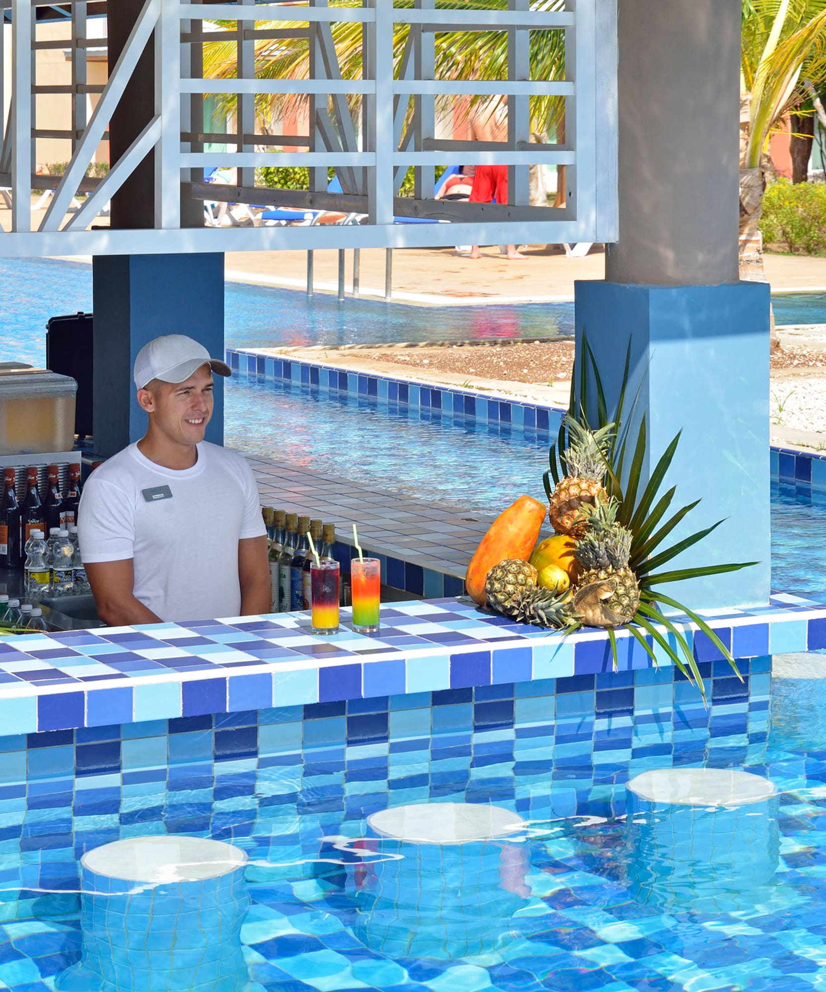a man behind a bar with drinks