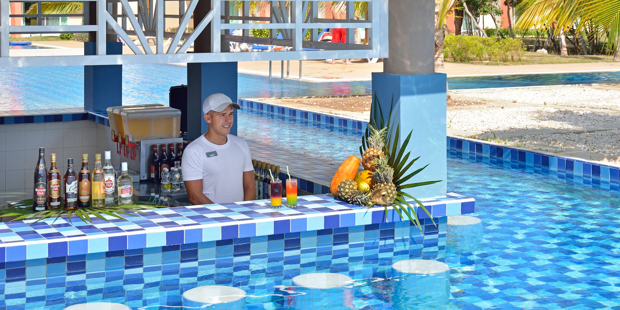 a man behind a bar with drinks
