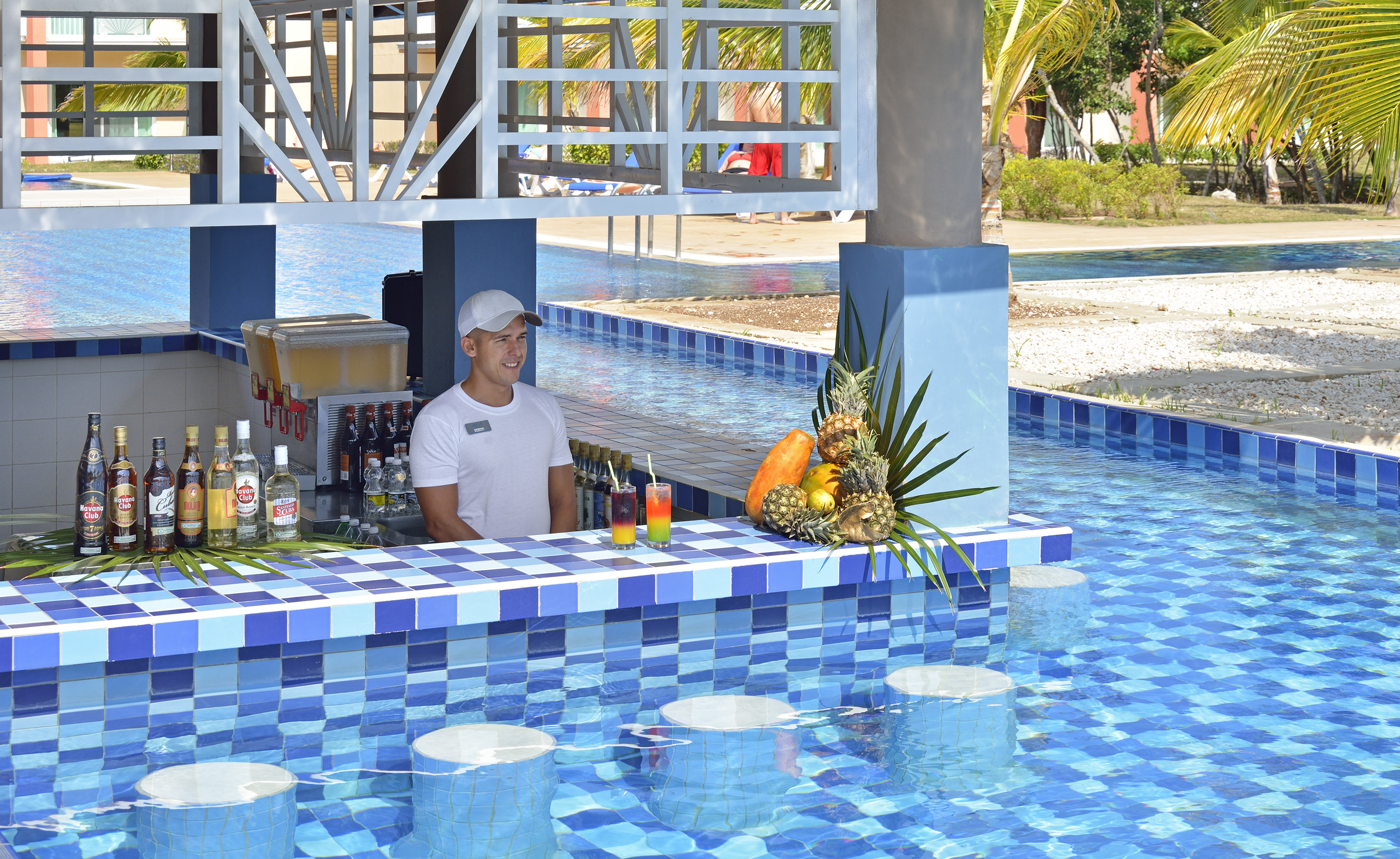 a man behind a bar with drinks