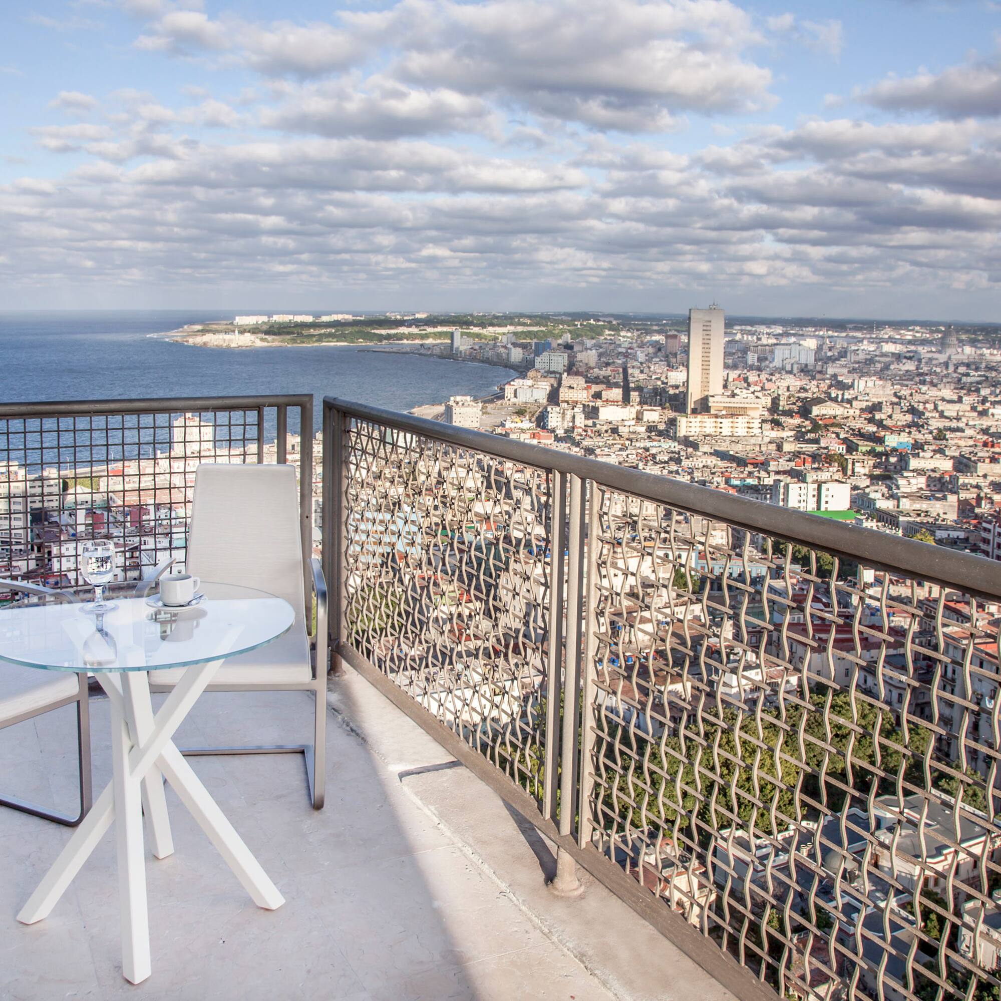 a table and chair overlooking a city