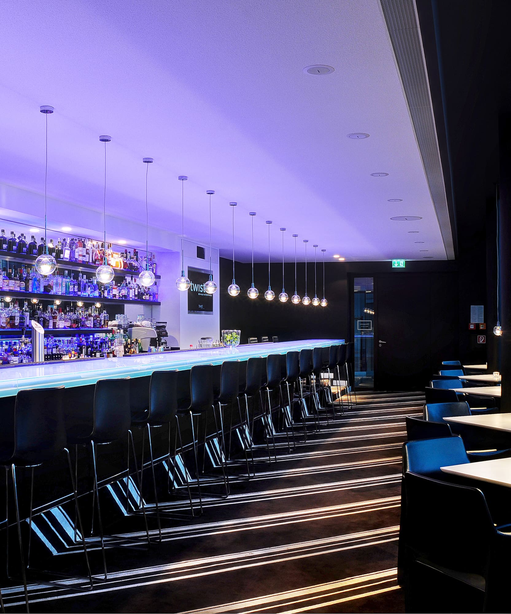 a bar with chairs and lights