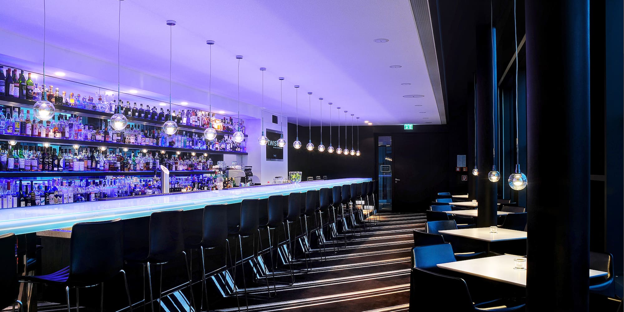 a bar with chairs and lights