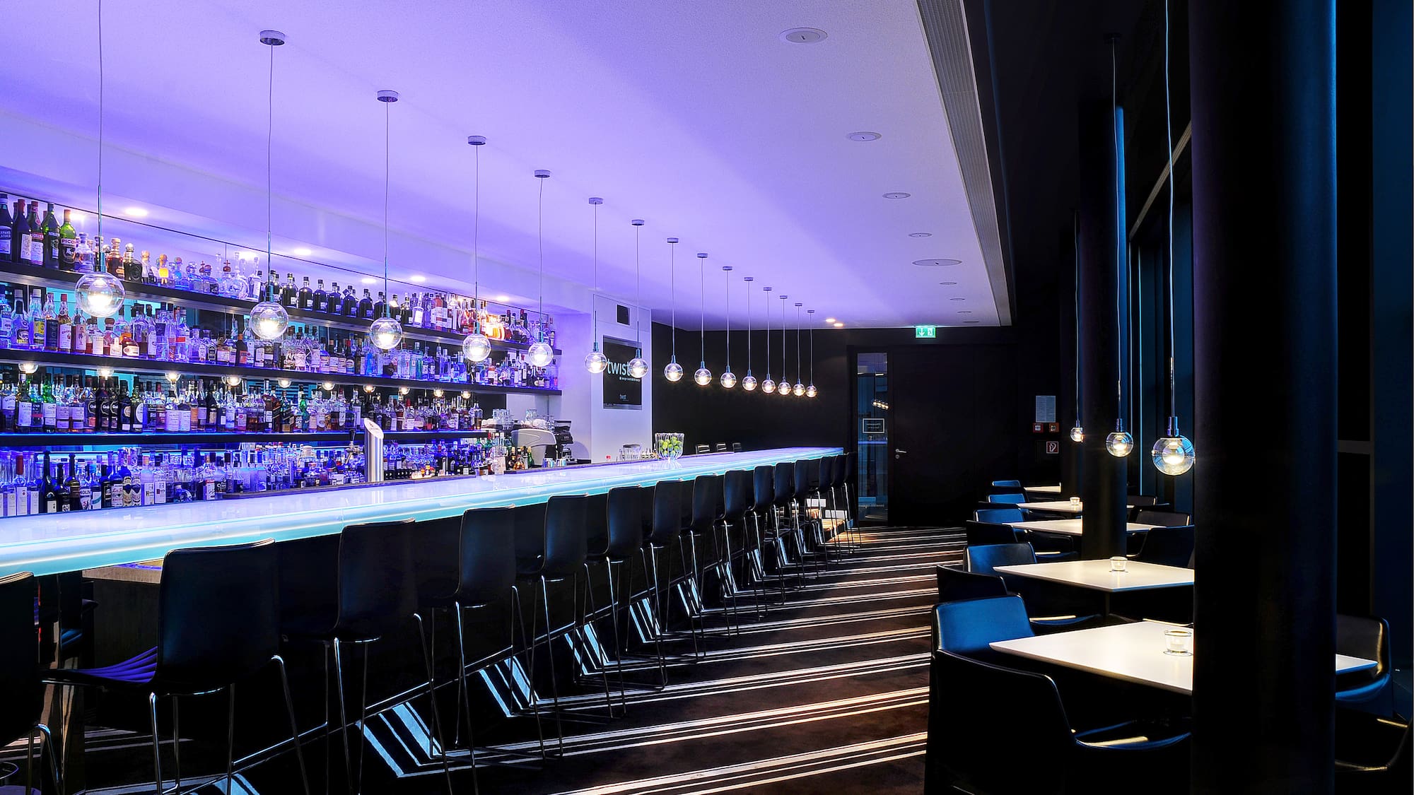 a bar with chairs and lights