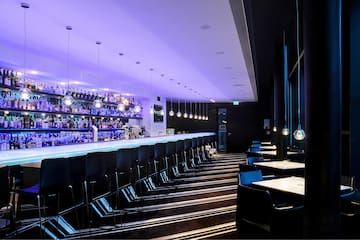 a bar with chairs and lights