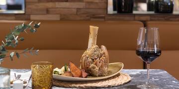 a plate of food and a glass of wine