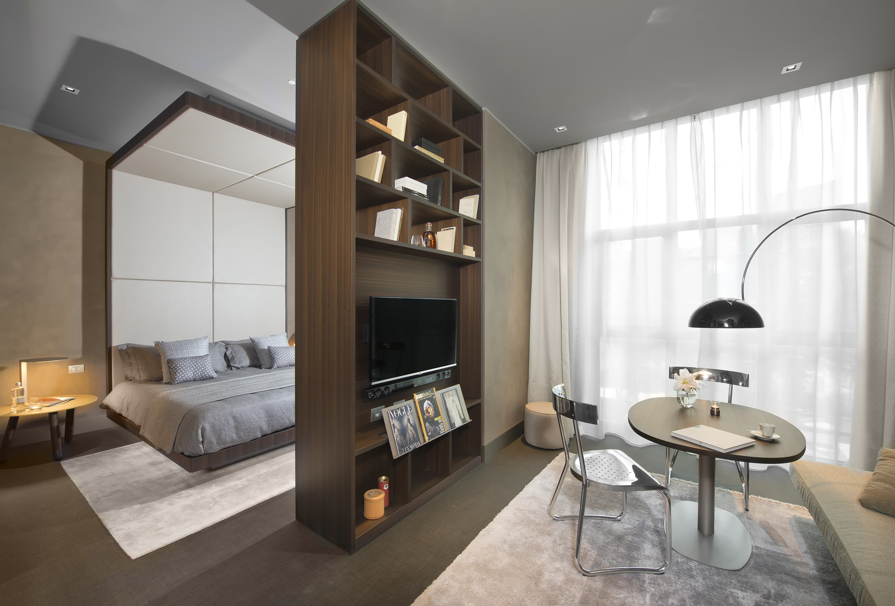 a room with a tv and a bed