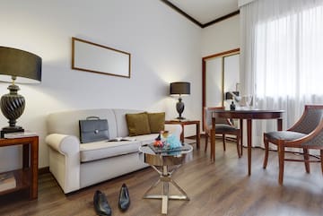 a room with a couch and table and chairs
