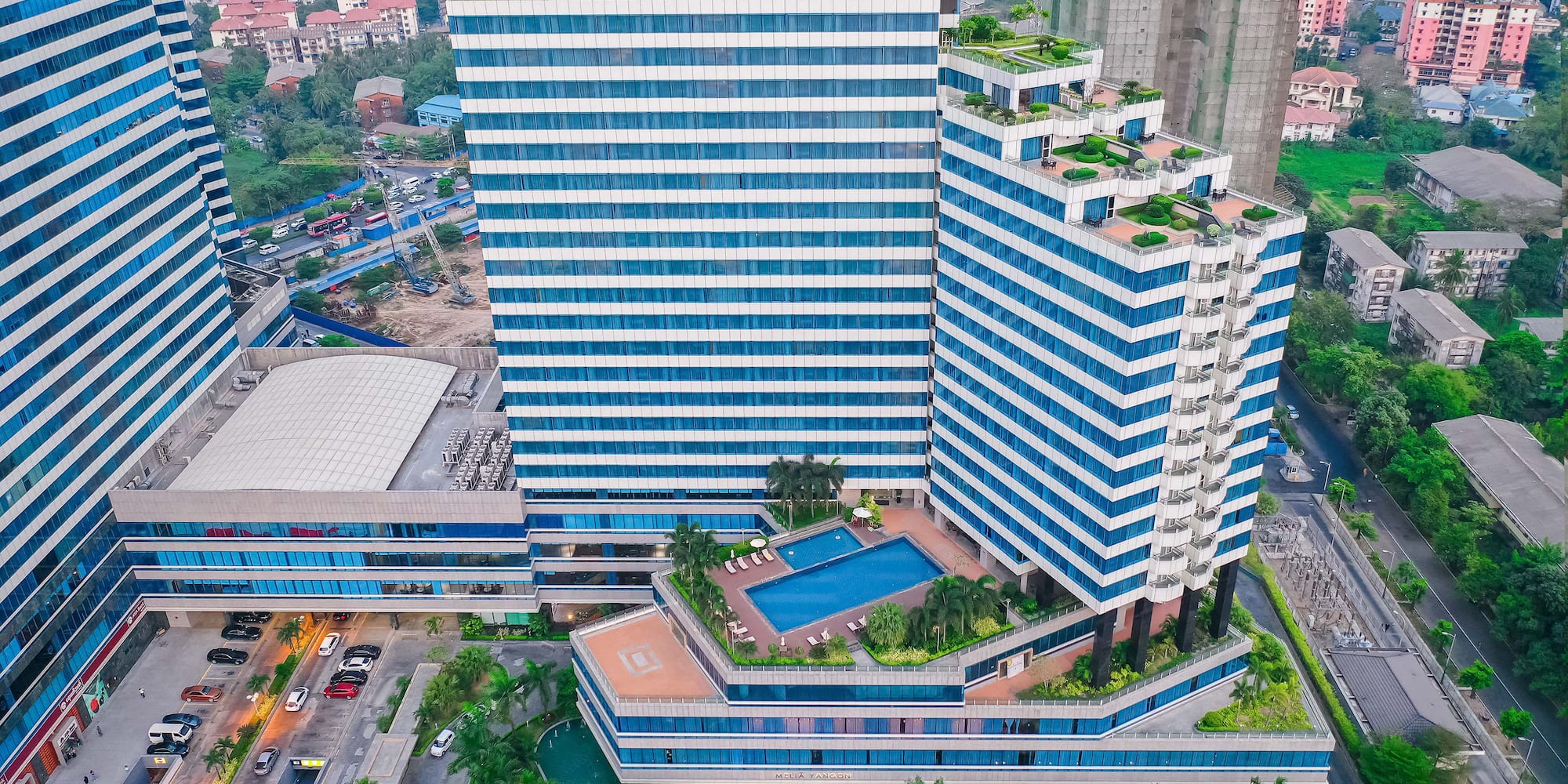 a large building with a pool in the middle of it
