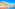 a beach with buildings and a hill