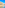 a beach with buildings and a hill