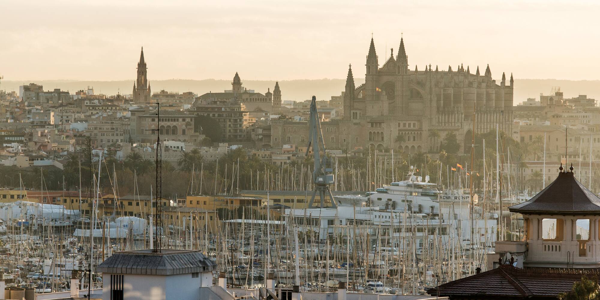 Palma de Mallorca city skyline, Gothic Cathedral, and marina with sailboats.