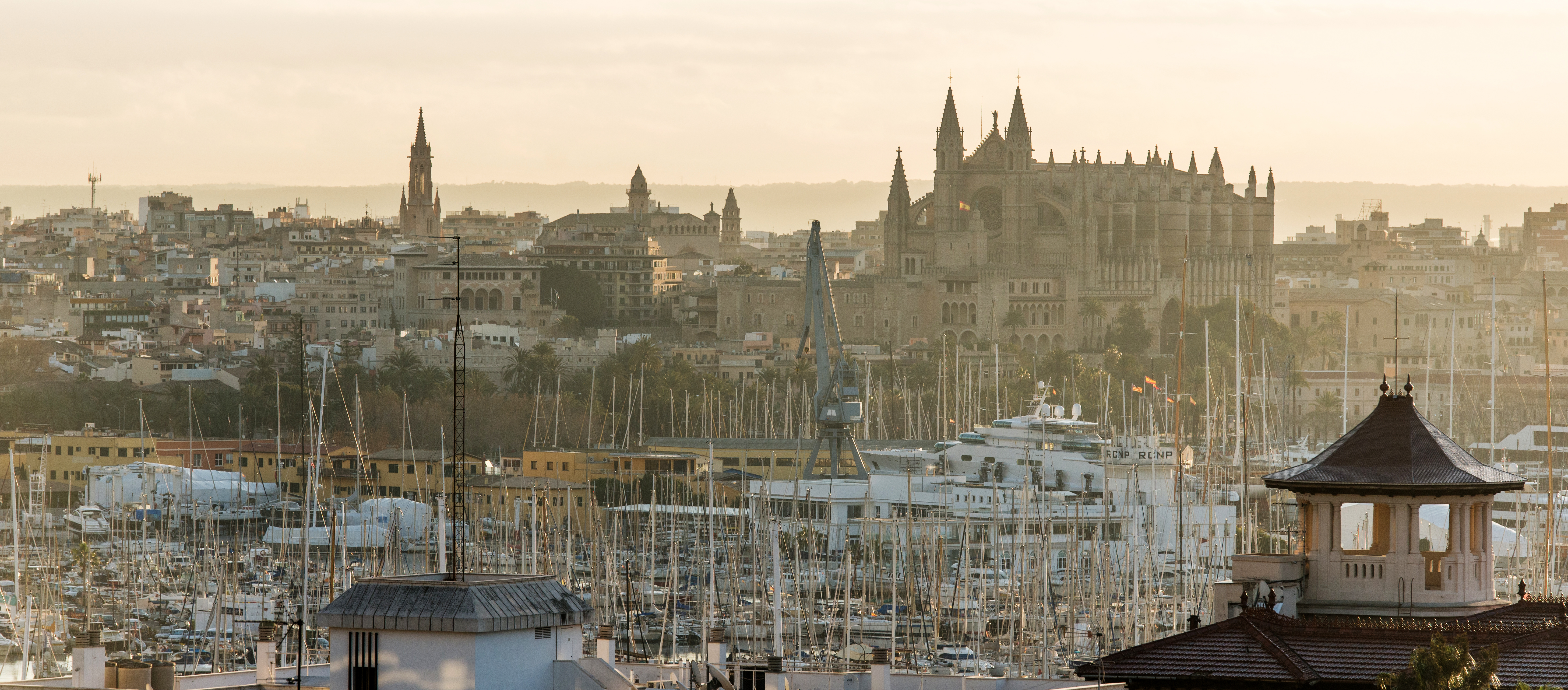 Palma de Mallorca city skyline, Gothic Cathedral, and marina with sailboats.