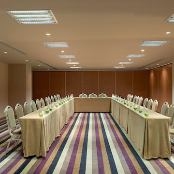 a long table set up in a room with chairs and a table with candles
