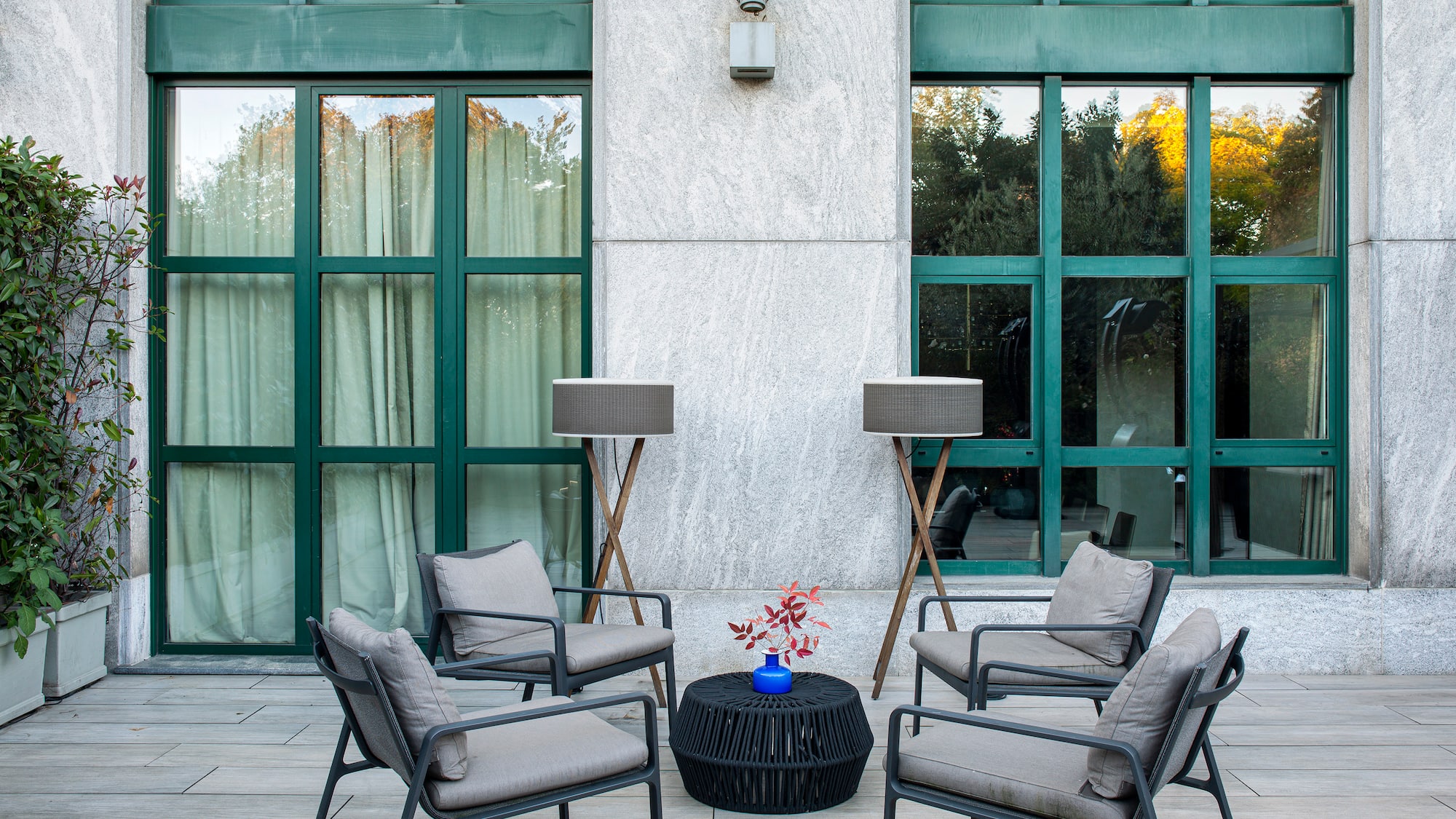 a patio with chairs and a table