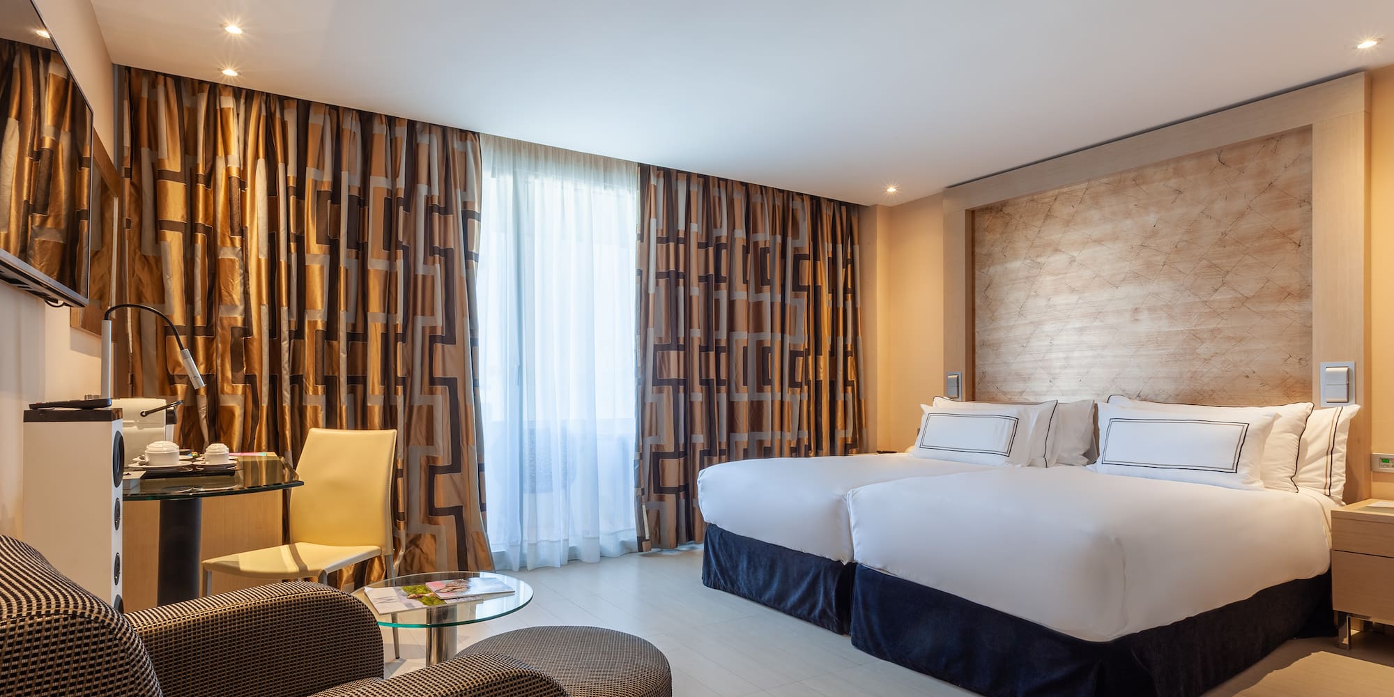 a room with two beds and a table