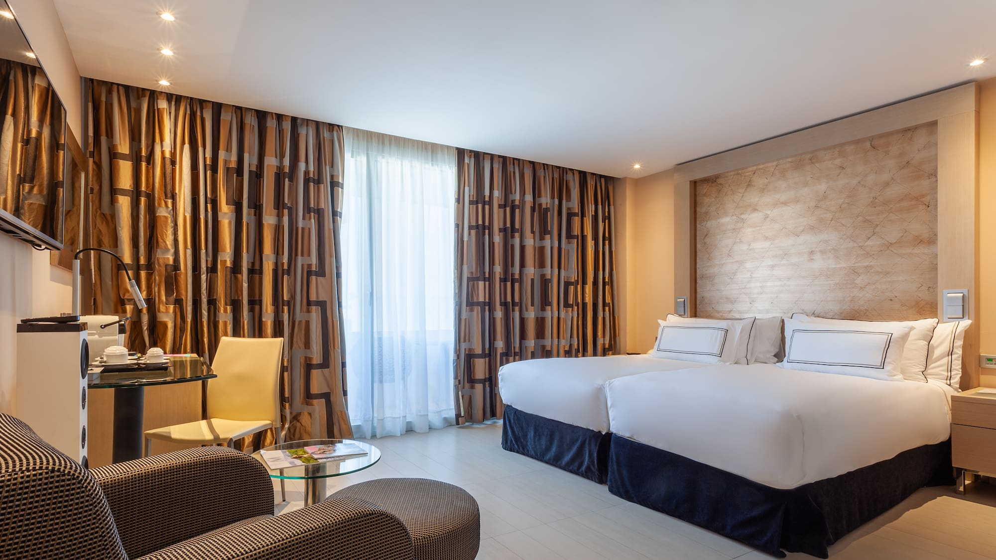 a room with two beds and a table