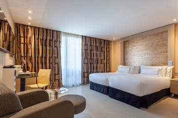 a room with two beds and a table