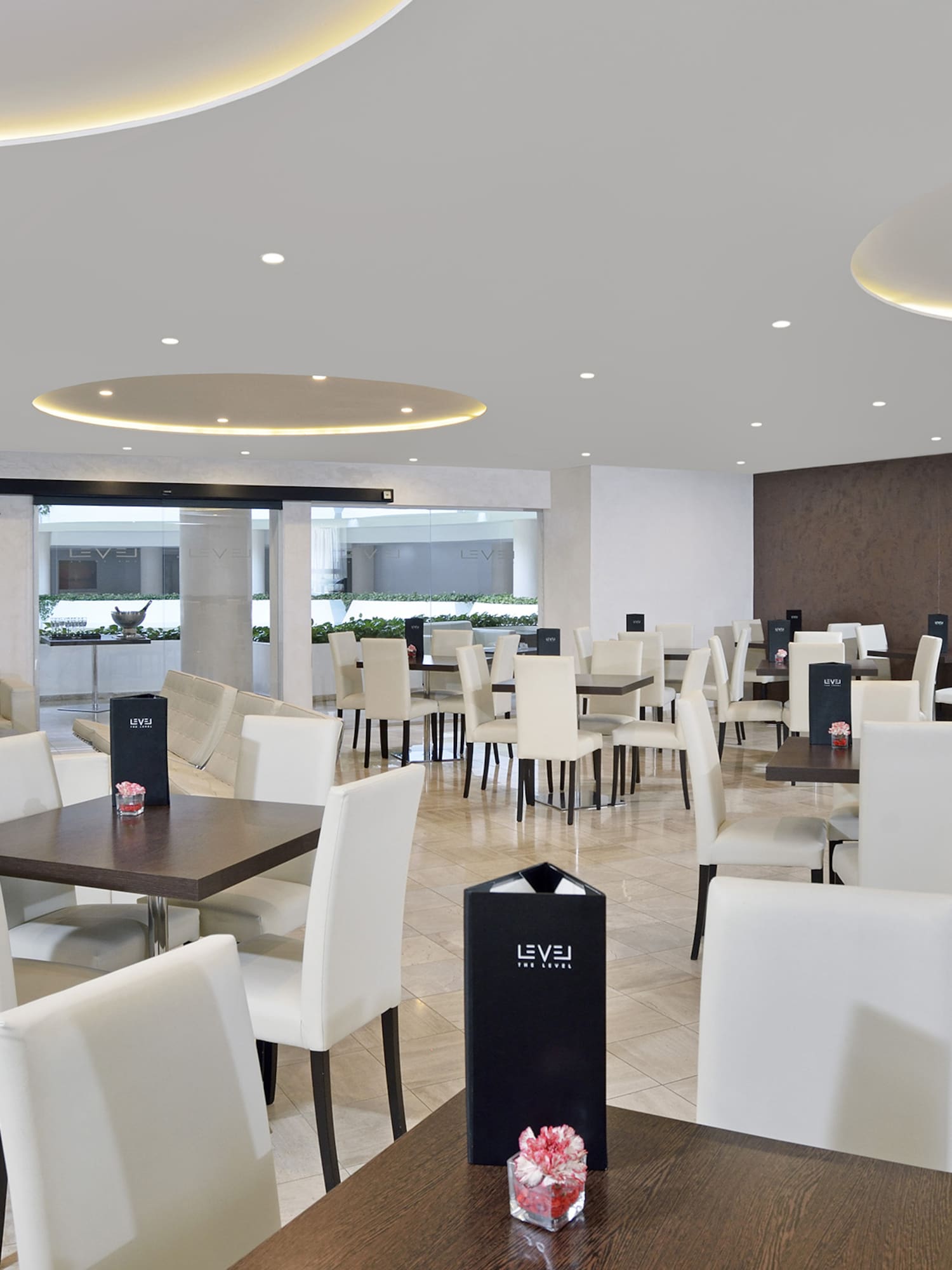 a room with white chairs and tables