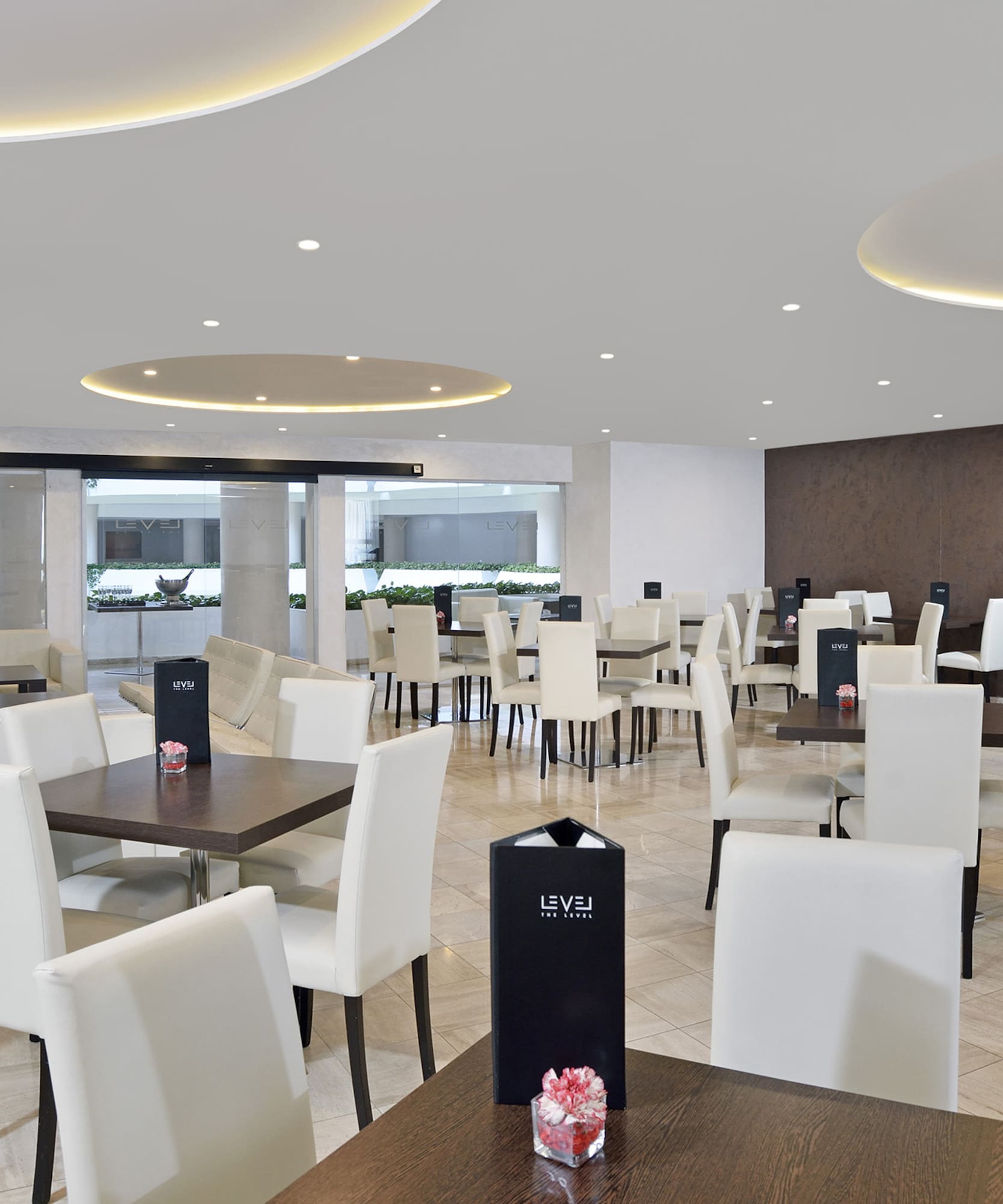 a room with white chairs and tables