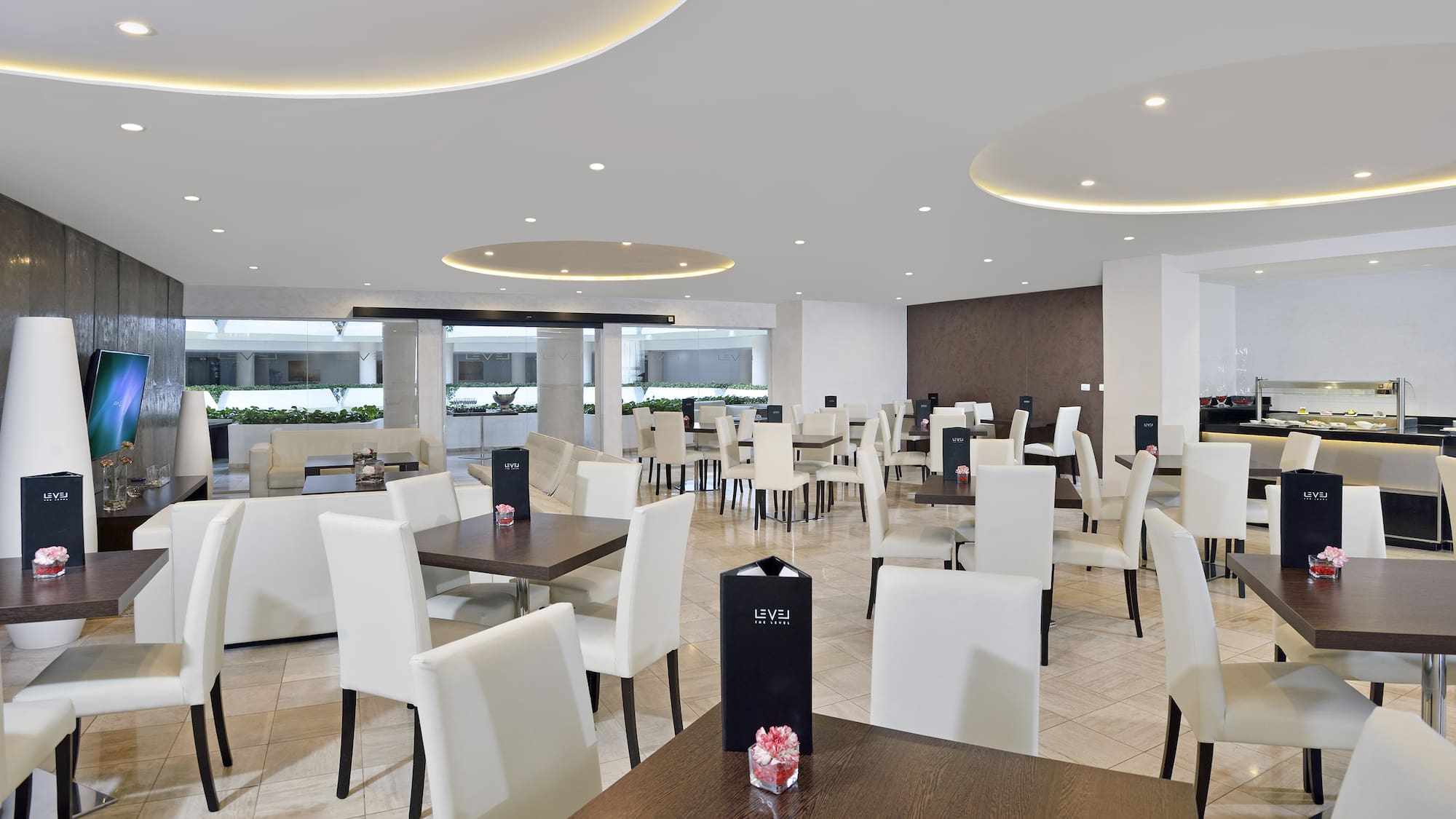 a room with white chairs and tables