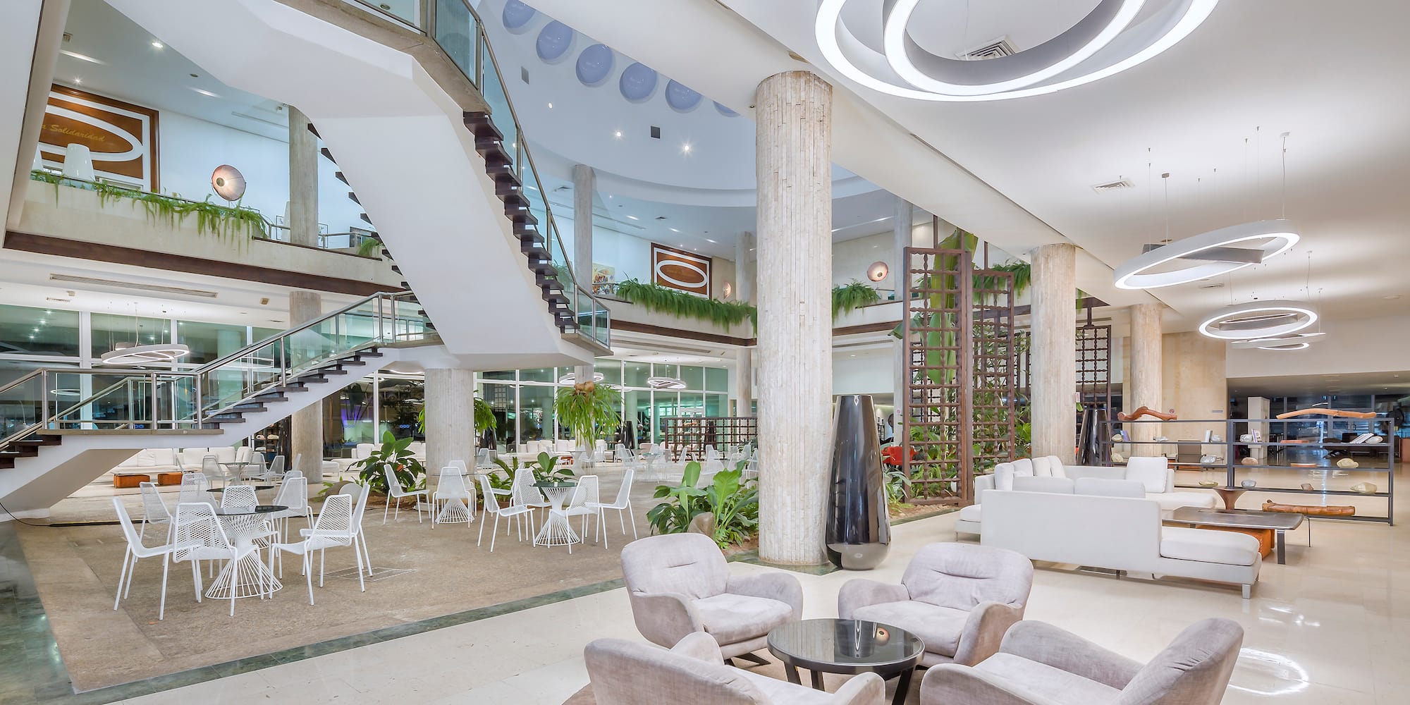 a large room with white chairs and tables