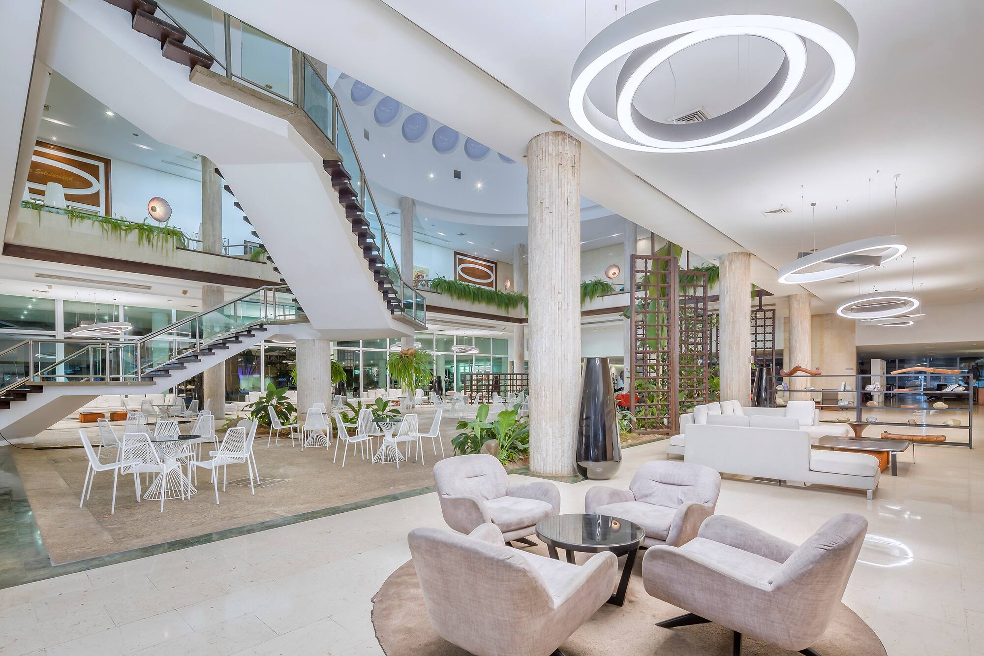 a large room with white chairs and tables