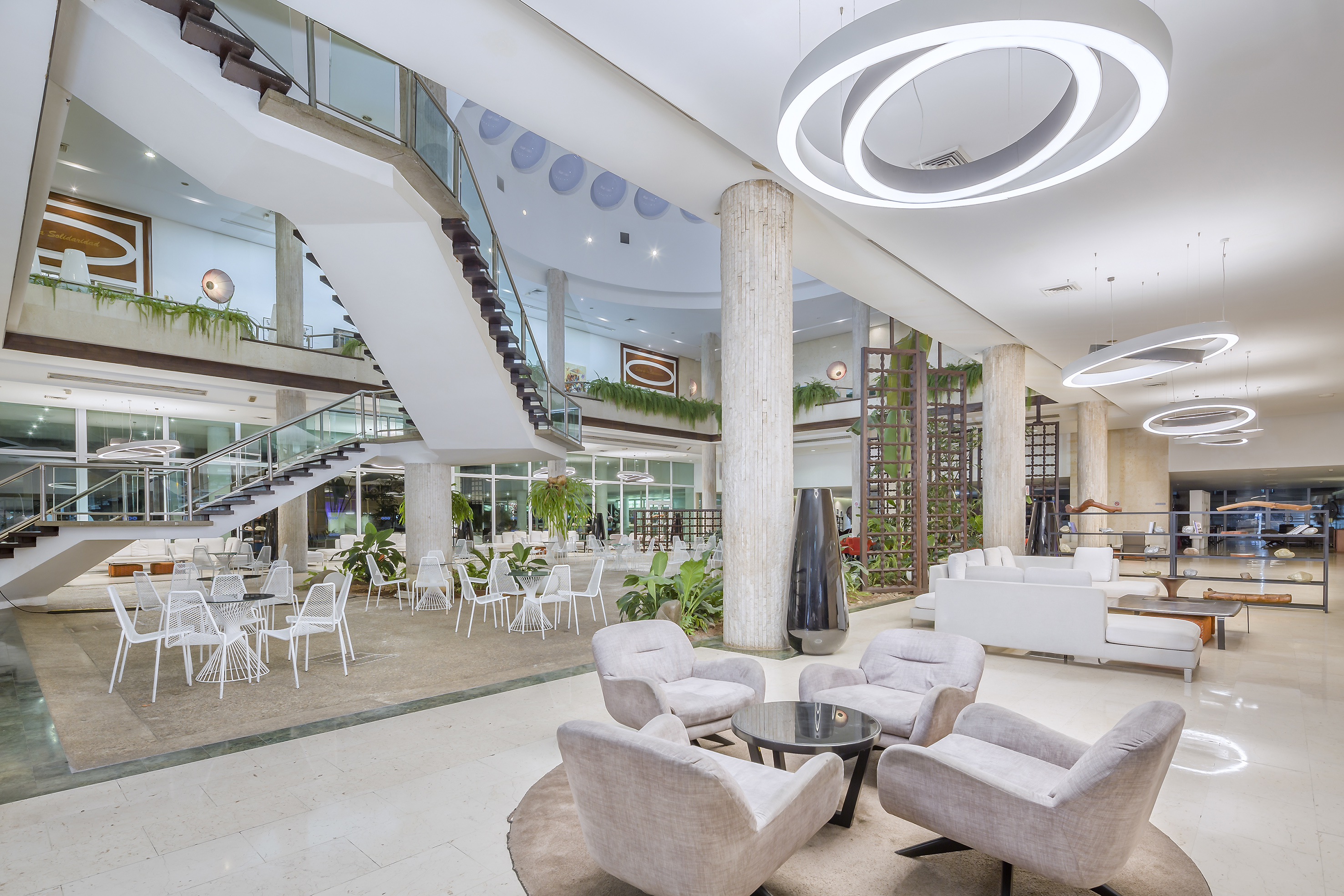a large room with white chairs and tables