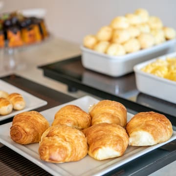 a plate of croissants and other food on a table