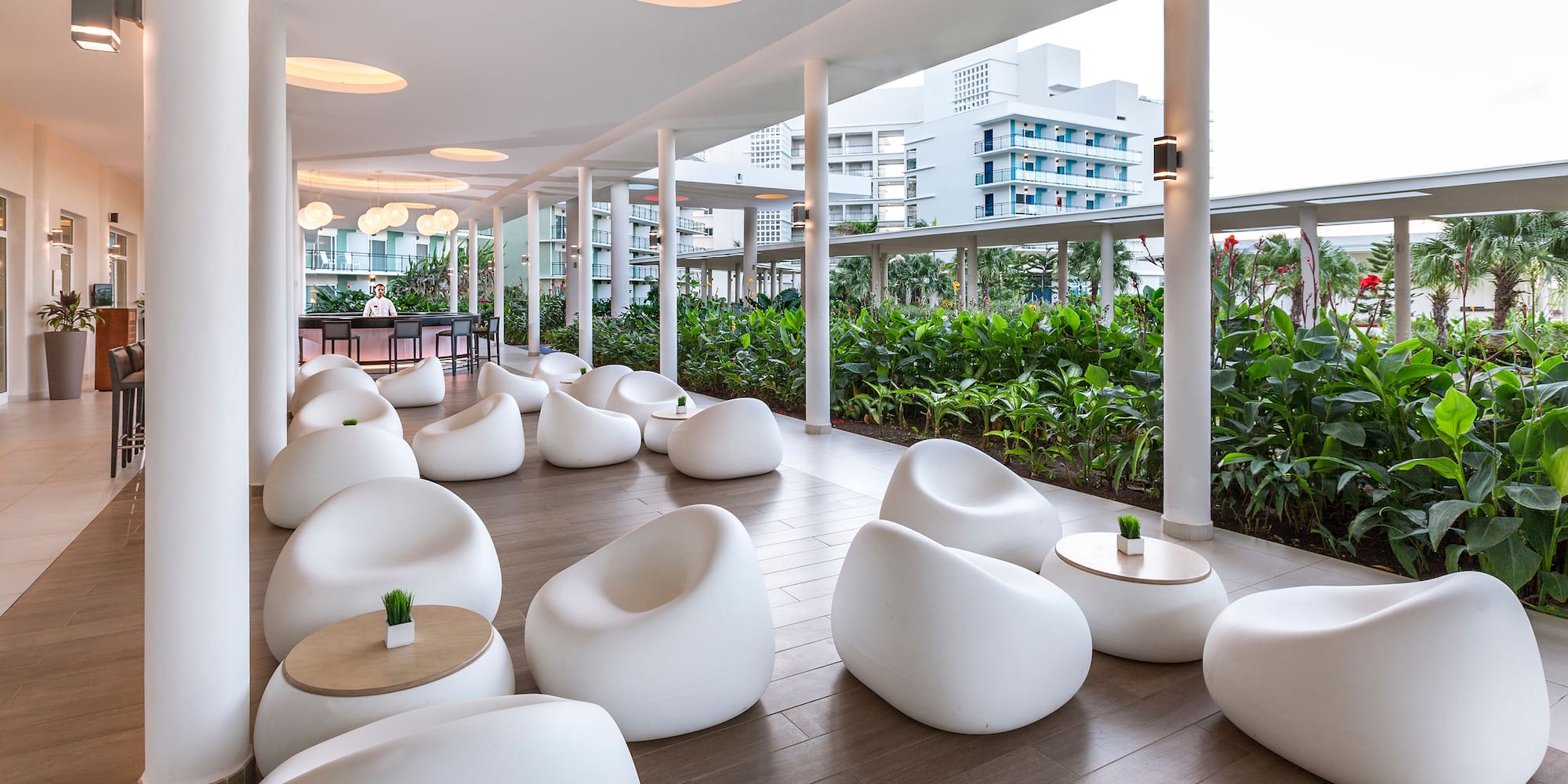 a room with white chairs and tables