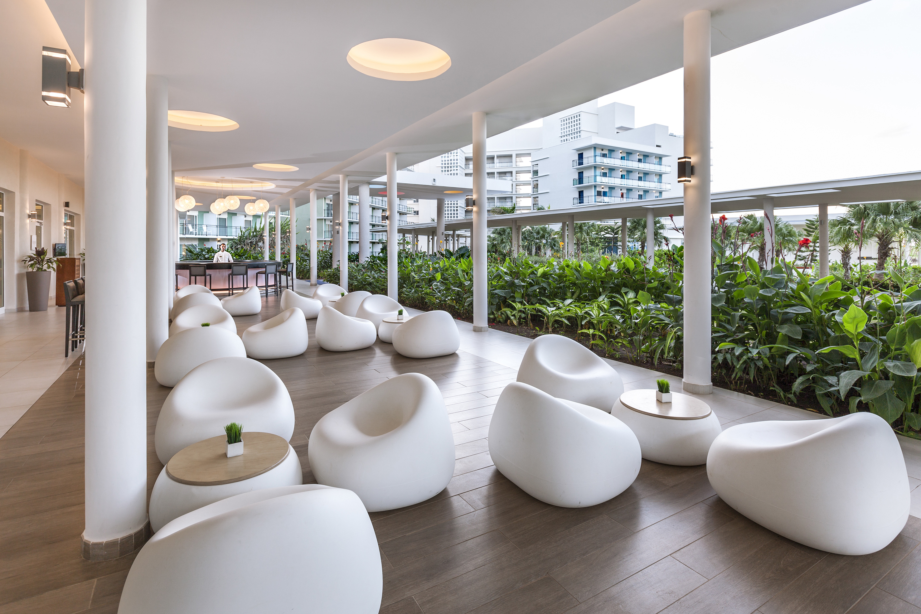 a room with white chairs and tables