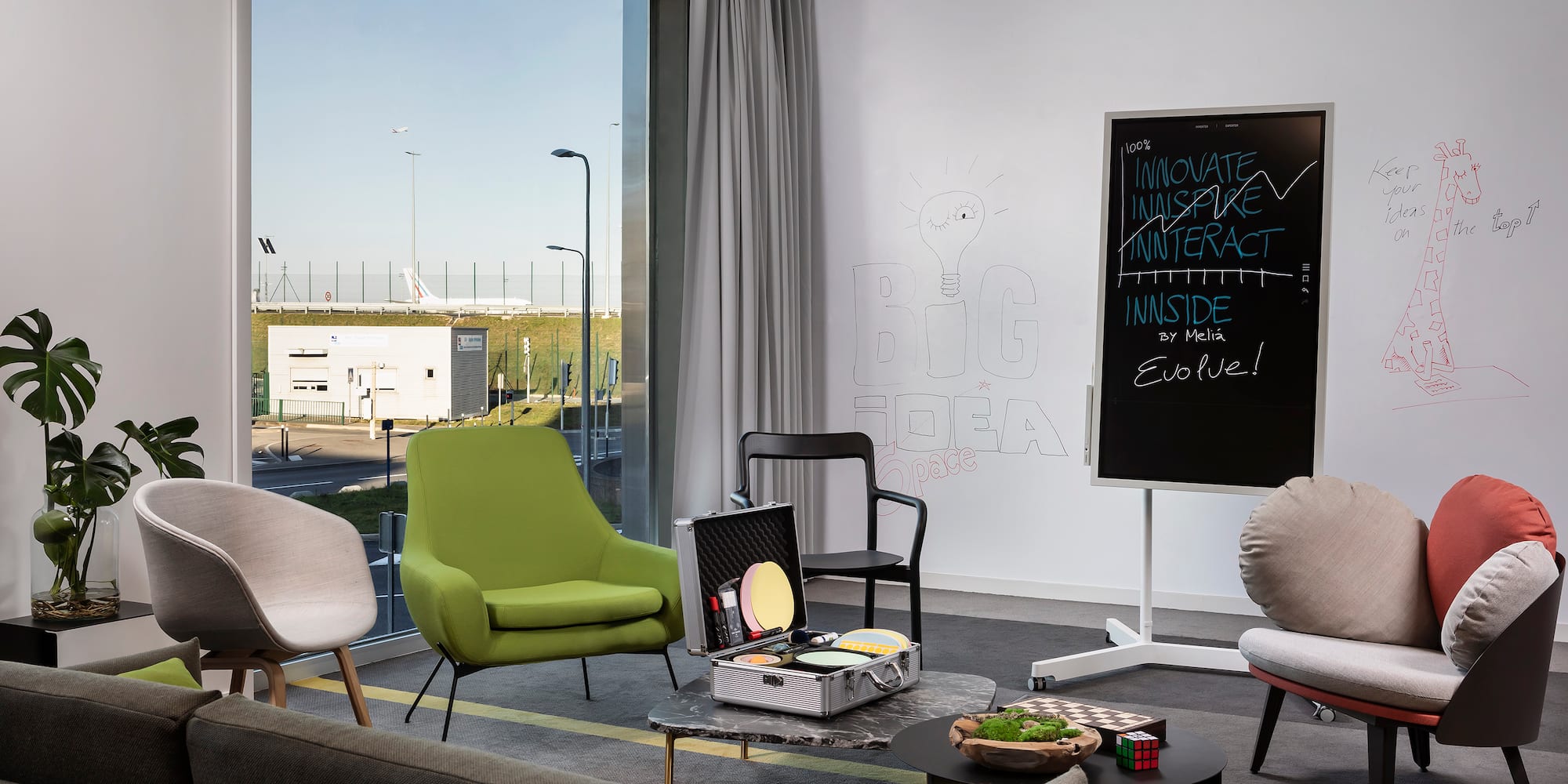 a room with chairs and a chalkboard