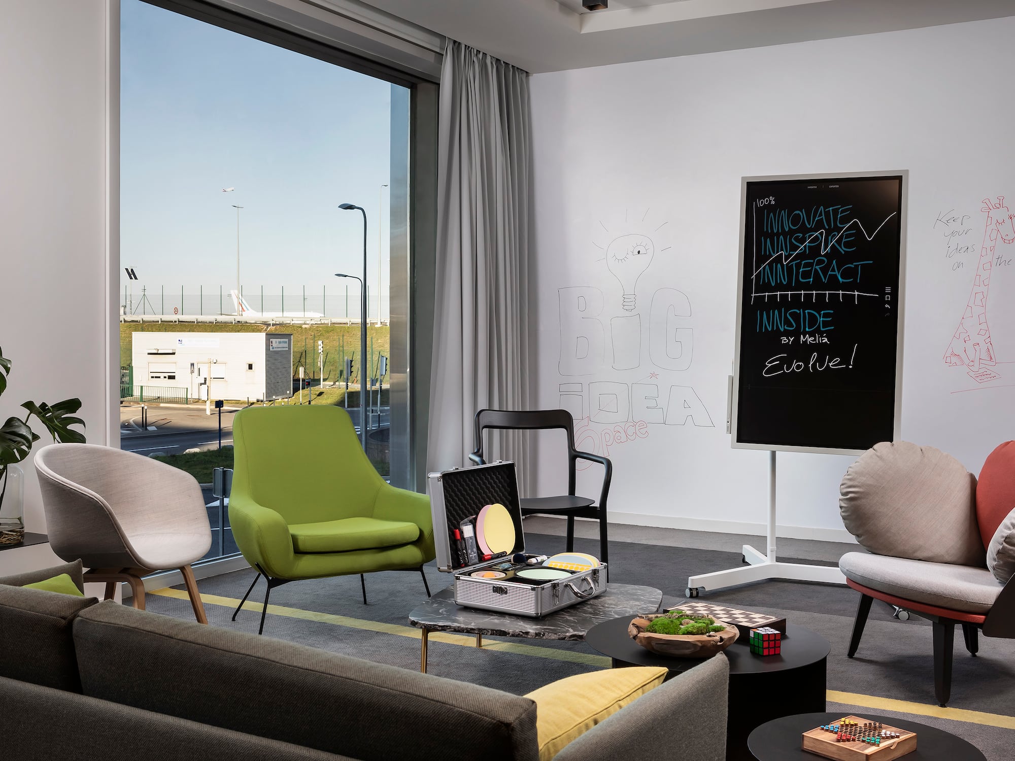 a room with chairs and a chalkboard