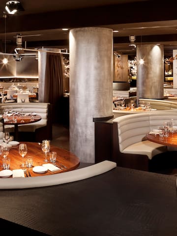 a restaurant with round tables and white seats