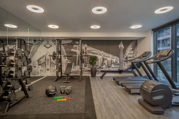 a gym with exercise equipment and a wallpaper
