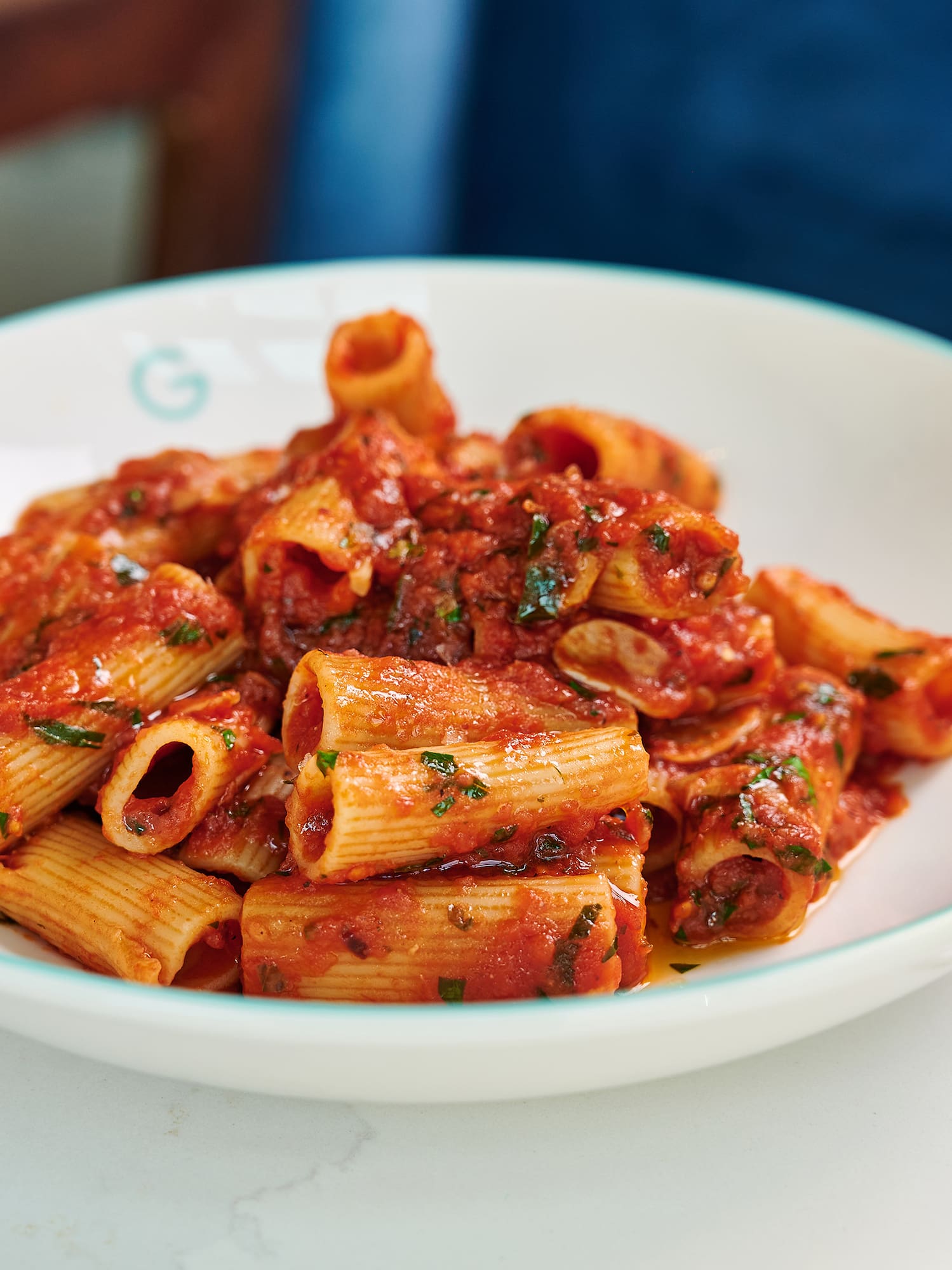 a plate of pasta with sauce and wine