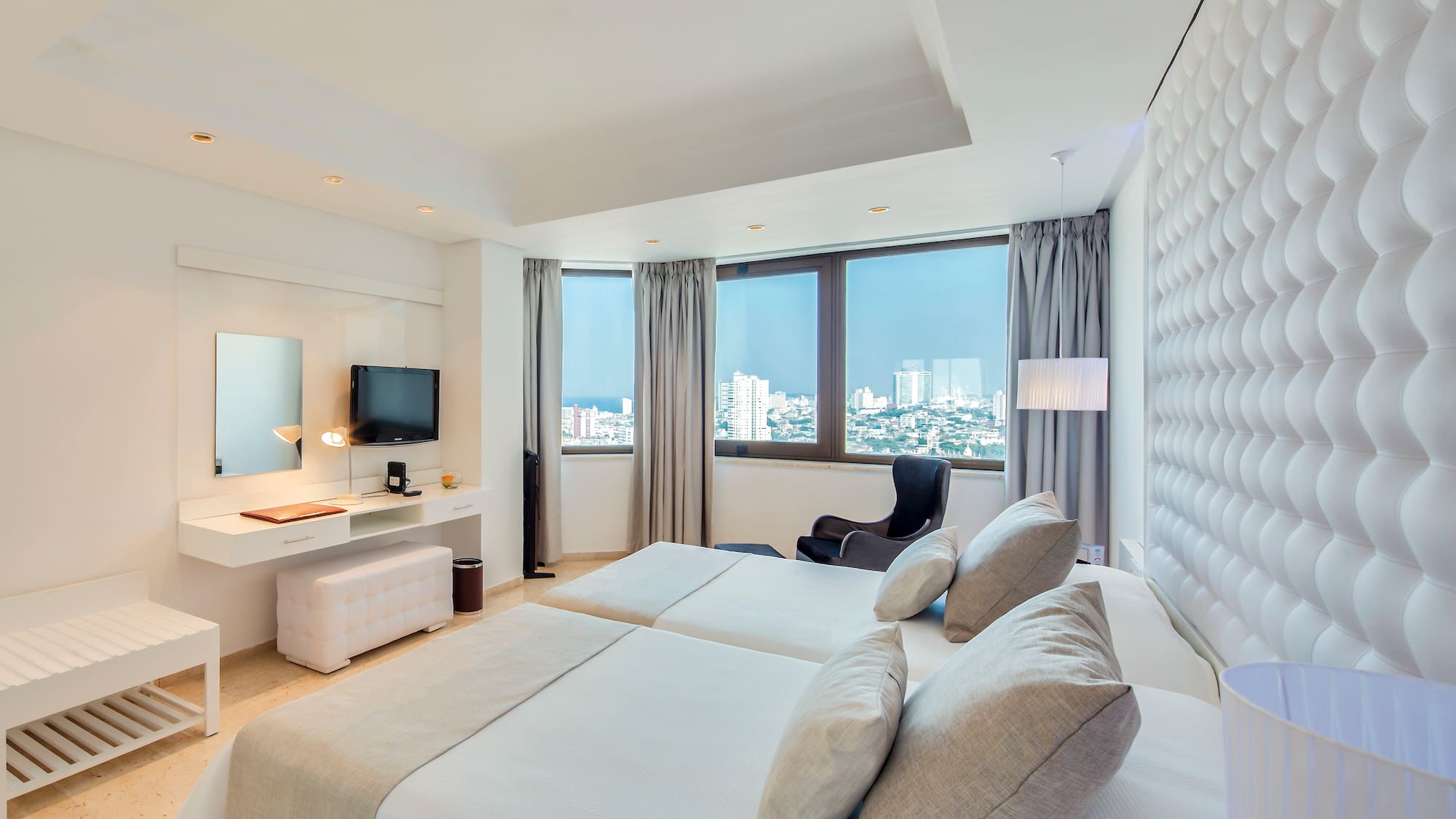 a room with two beds and a television