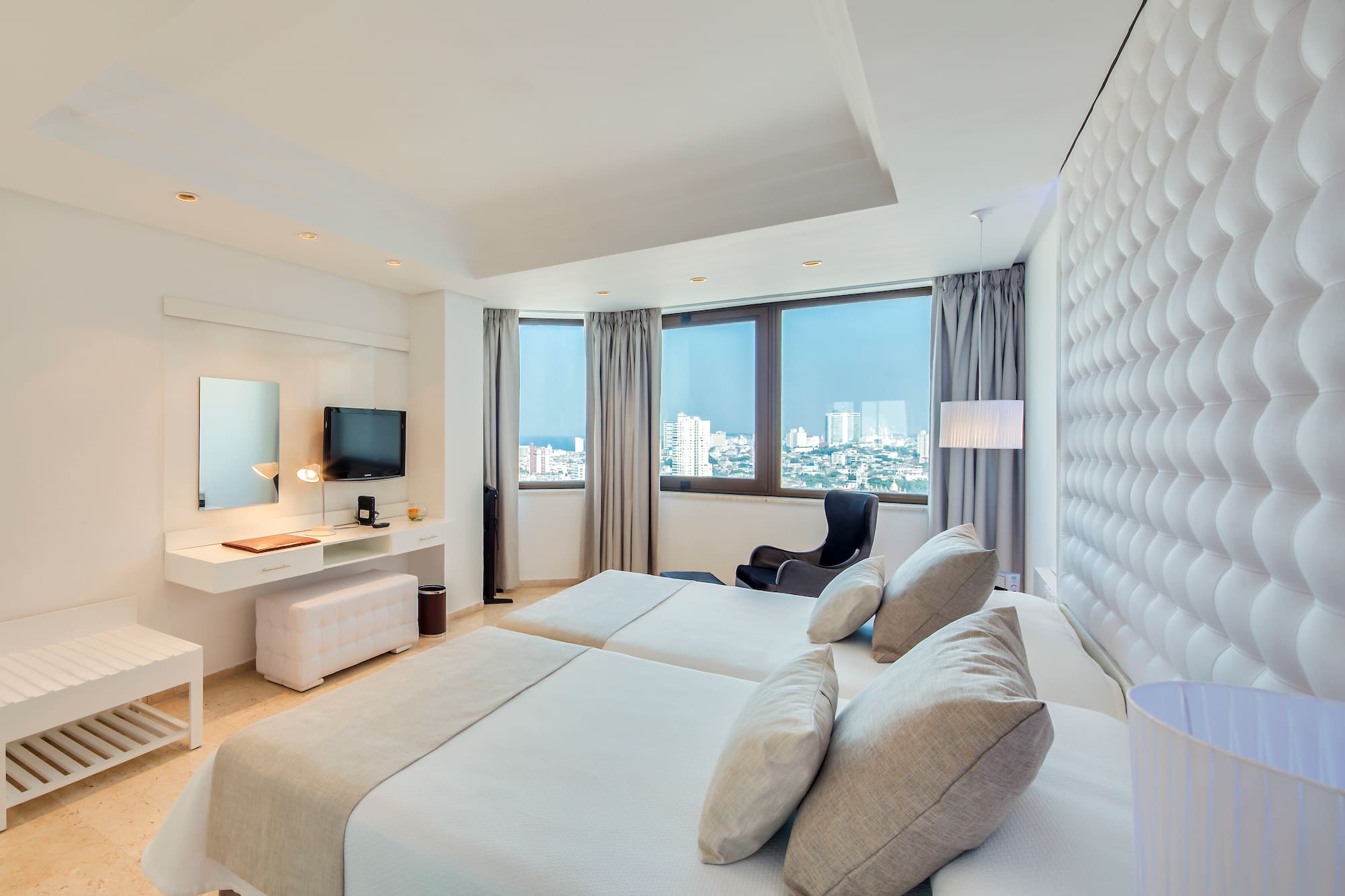 a room with two beds and a television