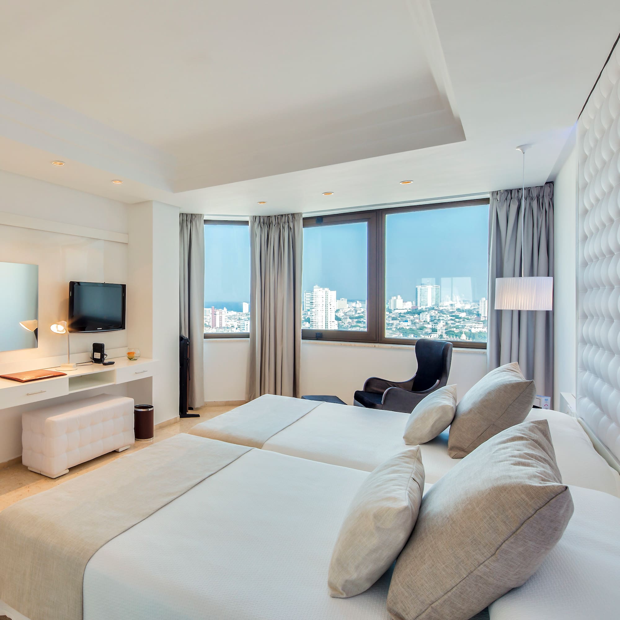 a room with two beds and a television