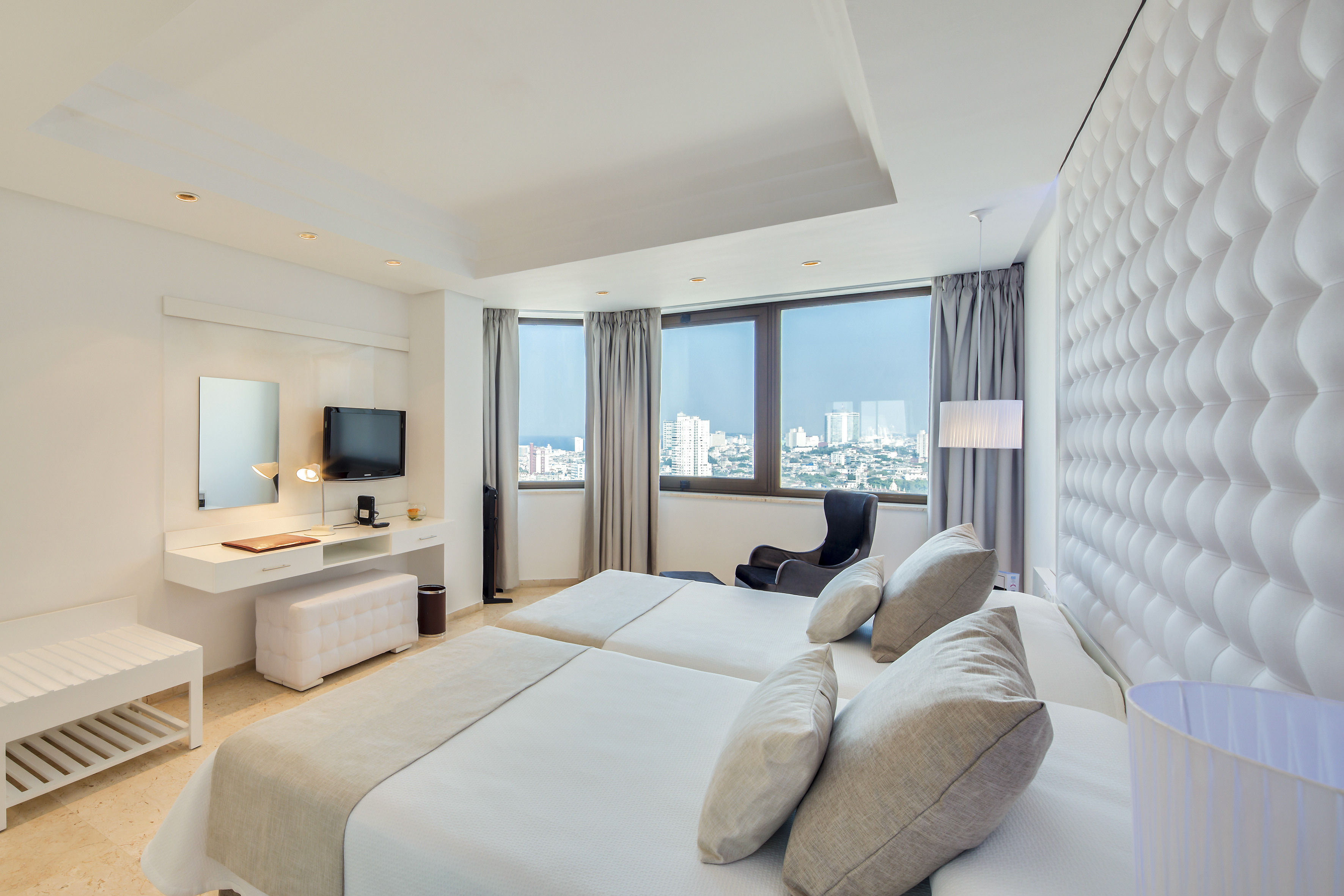 a room with two beds and a television