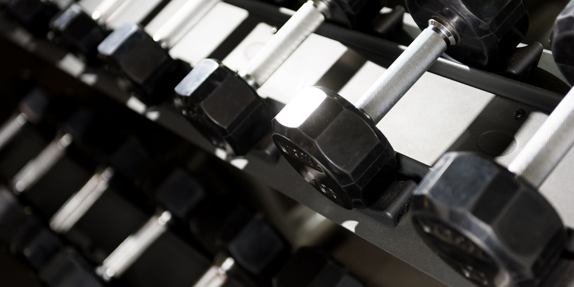 a close-up of a rack of dumbbells