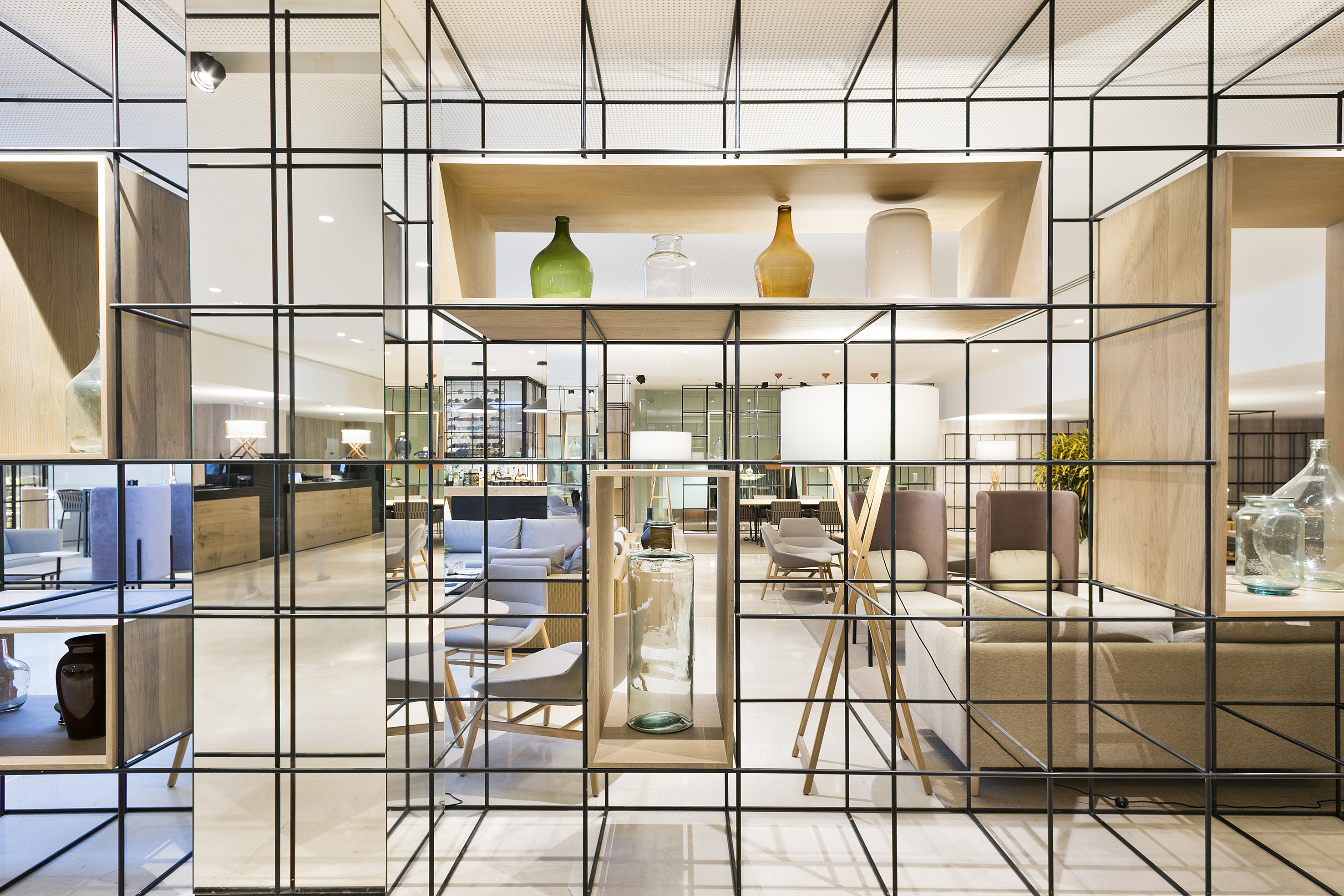 a glass wall with a shelf and a shelf with a chair and a table