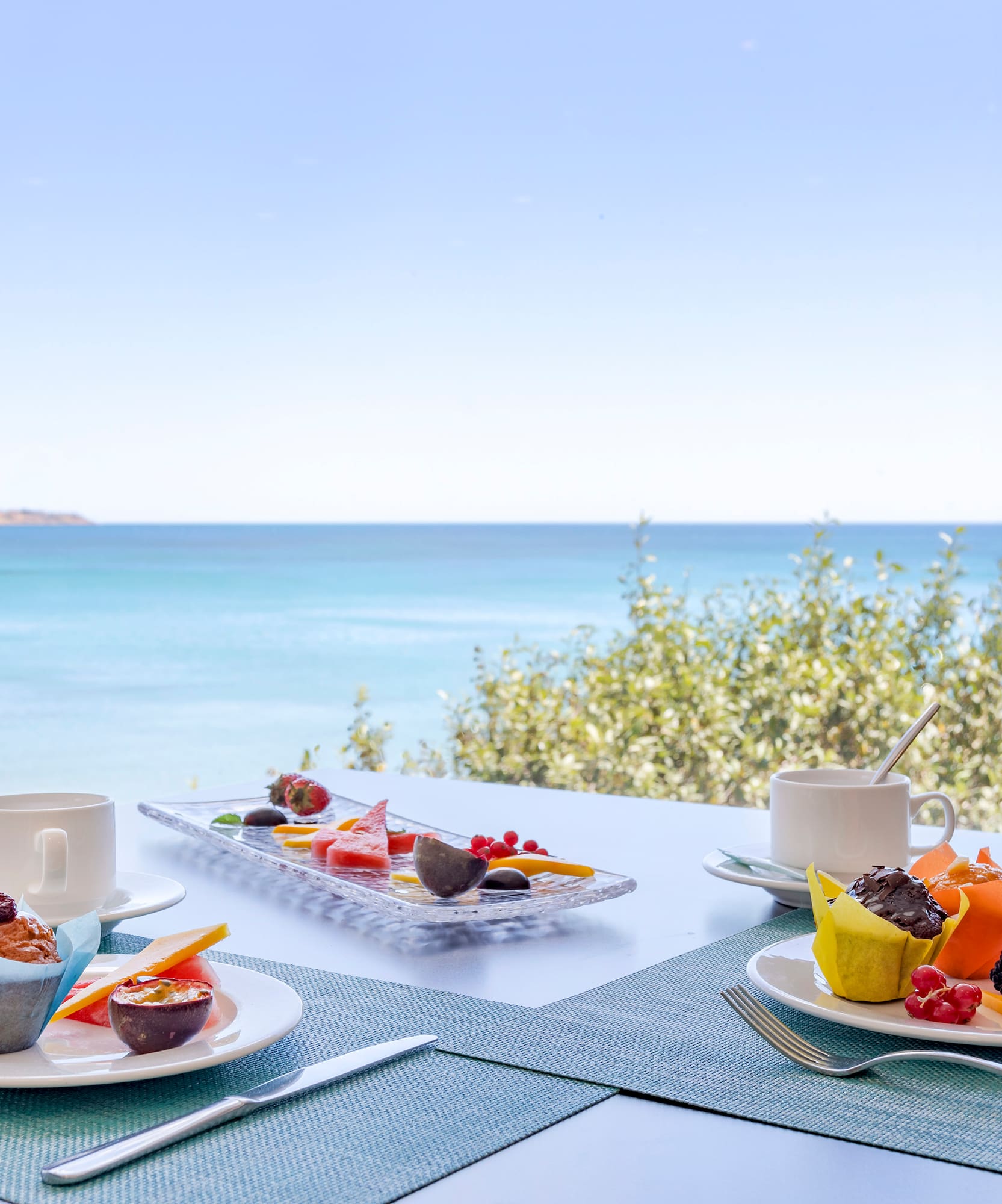 a table with plates of food and a cup of coffee on it