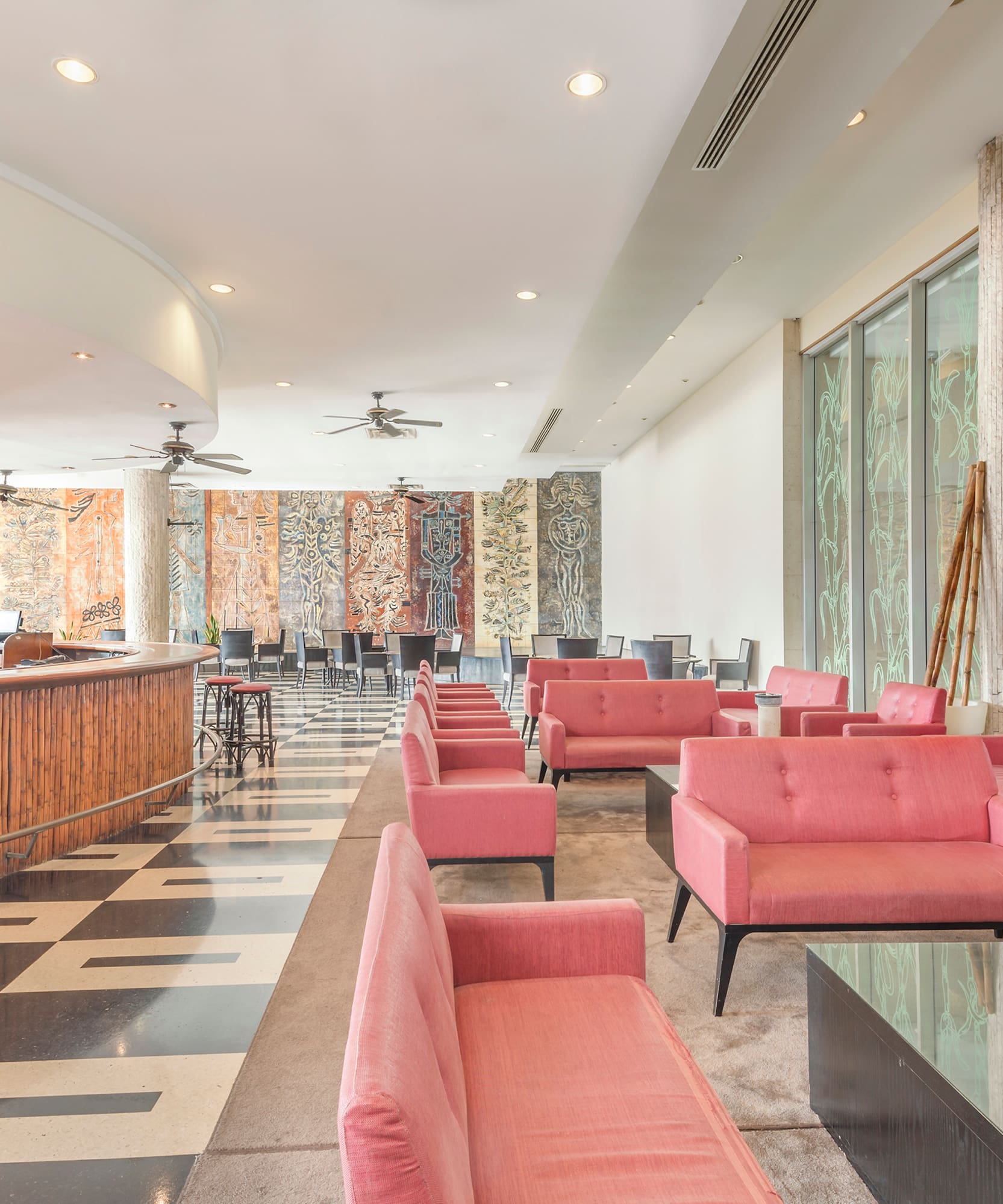 a room with pink couches and a black and white checkered floor