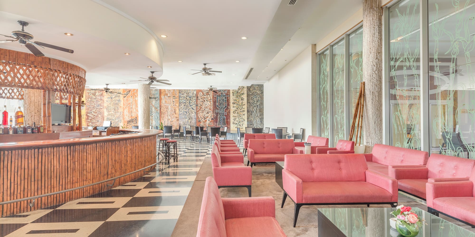 a room with pink couches and a black and white checkered floor